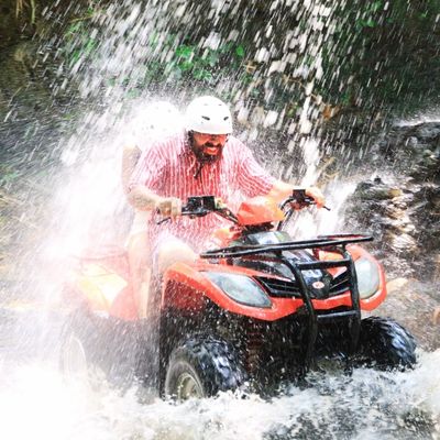 Couple traveller enjoying ATV ride in Bali